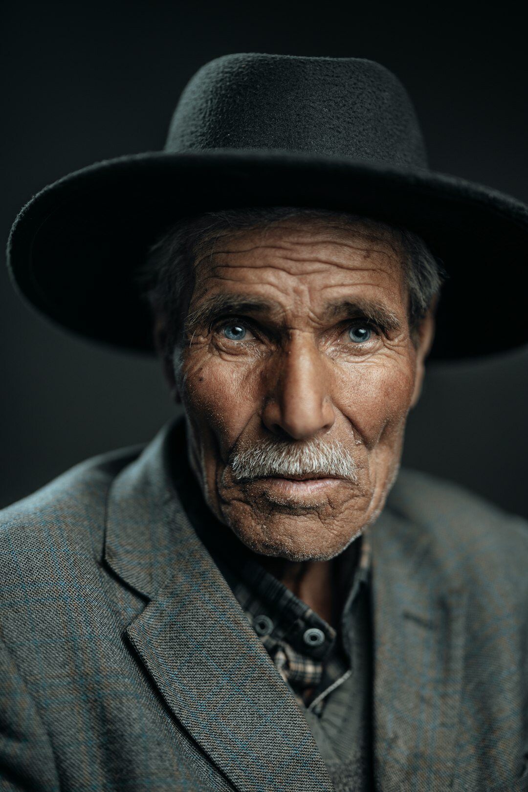 Studio portrait of an older man with gray hair