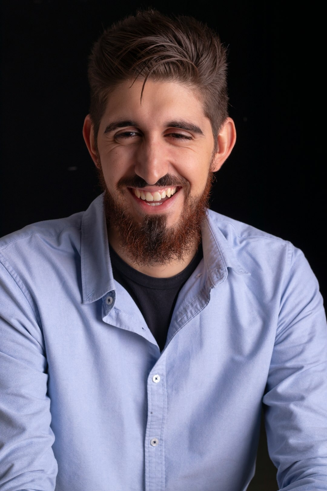 Studio portrait of a smiling man with short beard